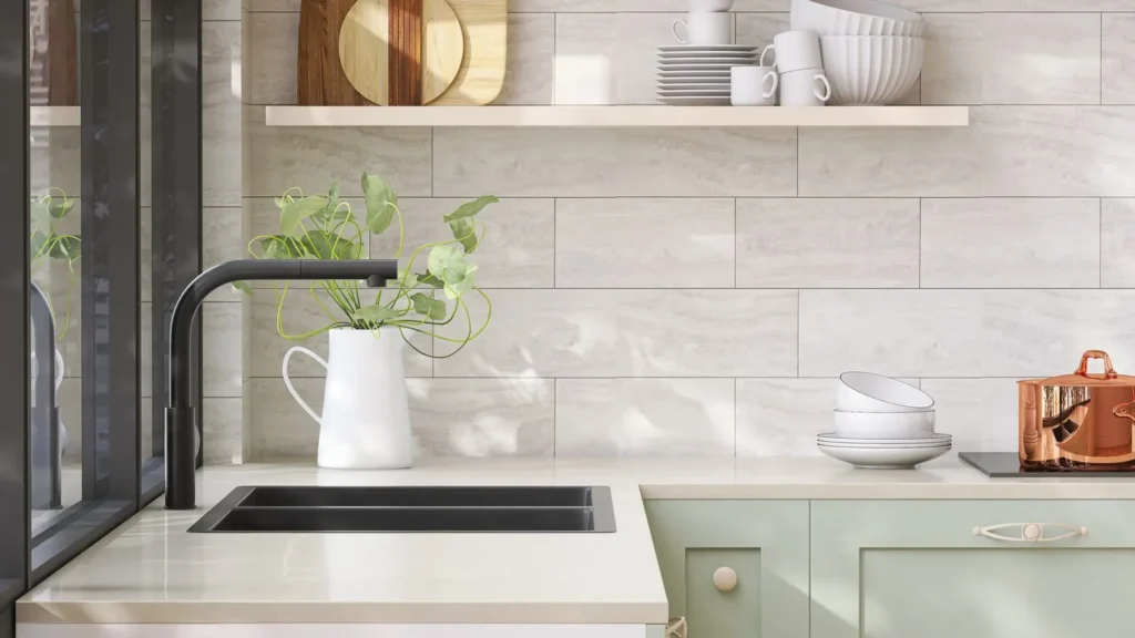 A modern kitchen with laminate countertop and a sink fitted in it, also some utensils on shelf