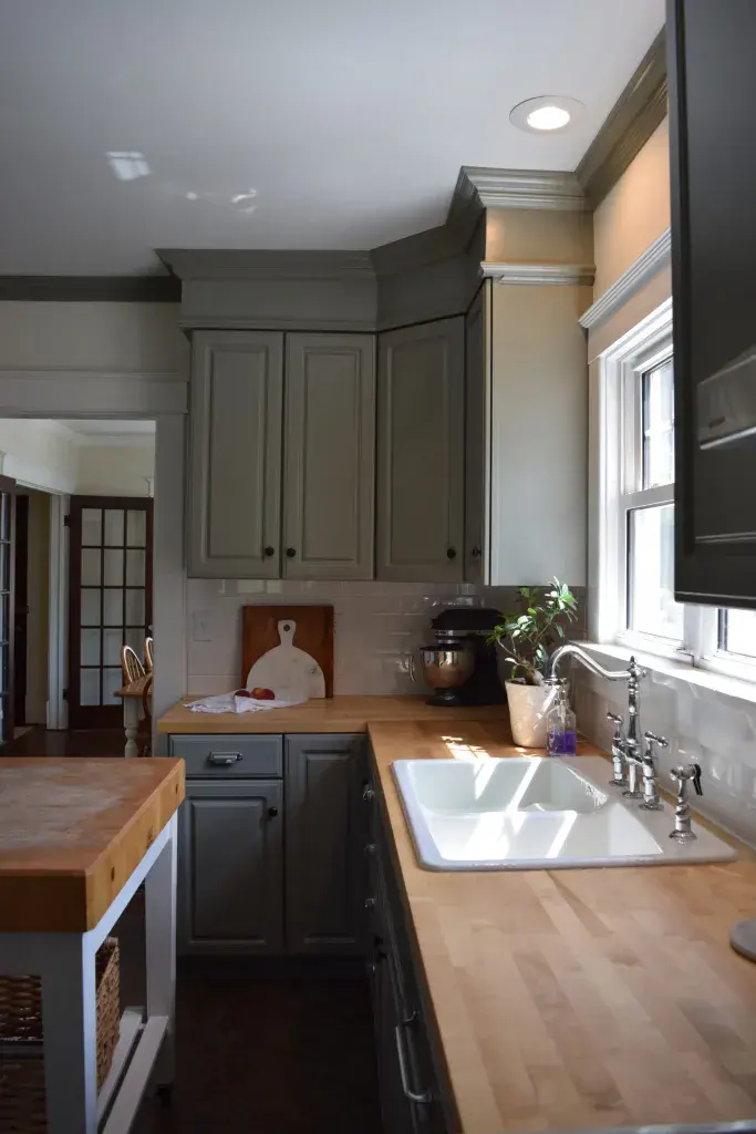 A beautiful Kitchen with butcher block countertop having white sink