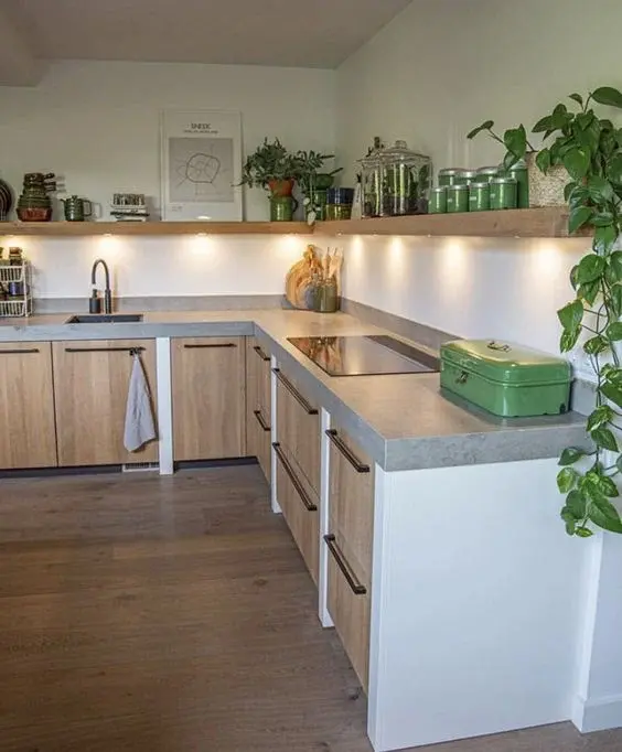 a modern kitchen with concrete countertop with stove and sink fitted in. 