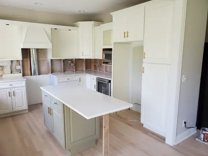 A beautiful kitchen with cabinets having Sherwin Williams Alabaster (SW 7008)