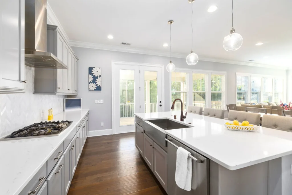 A beautiful Kitchen with beautiful countertops. One countertop has sink fitted in it and other has a stove fitted in it.  