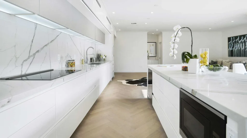 A beautiful white themed kitchen with quartz countertop