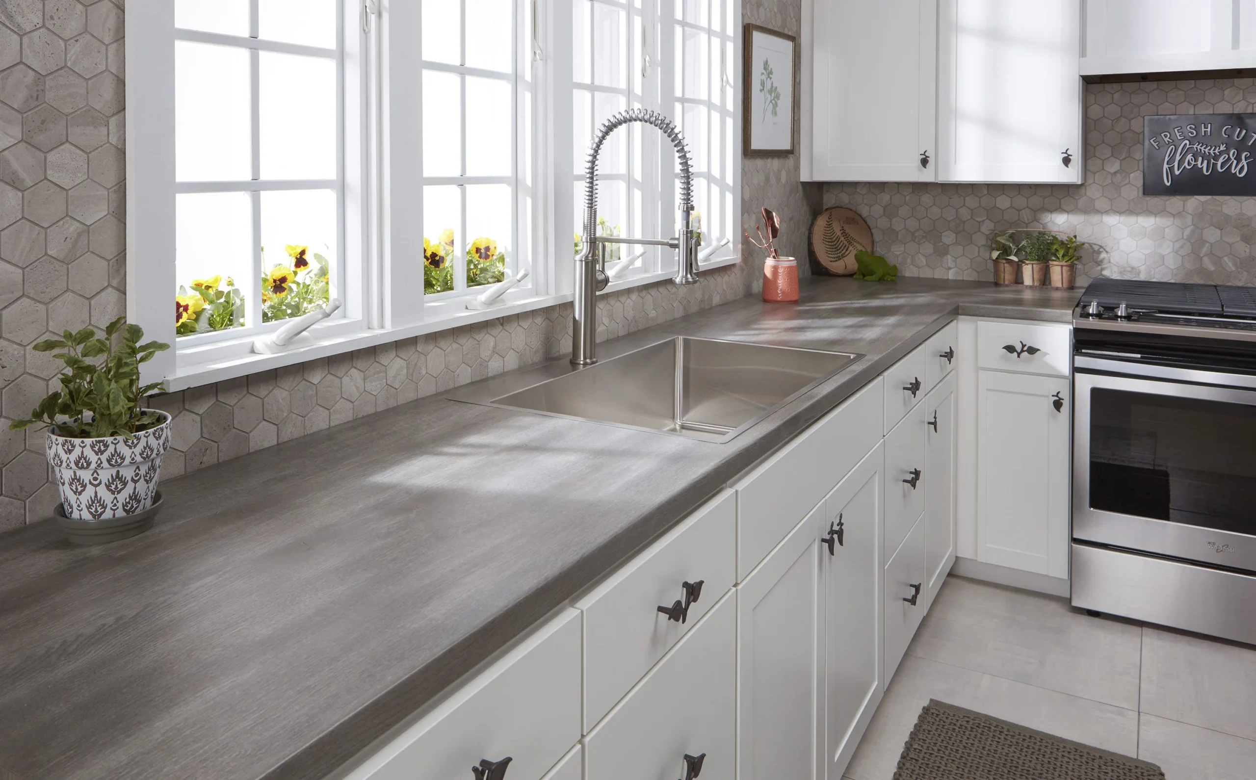 A beautiful Kitchen with Laminate Countertop and white cabinets