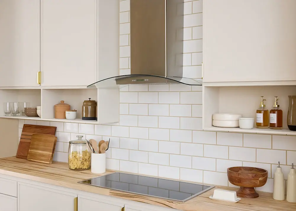 A beautiful kitchen with White Subway Tile backsplash with Butcher Block Kitchen countertop