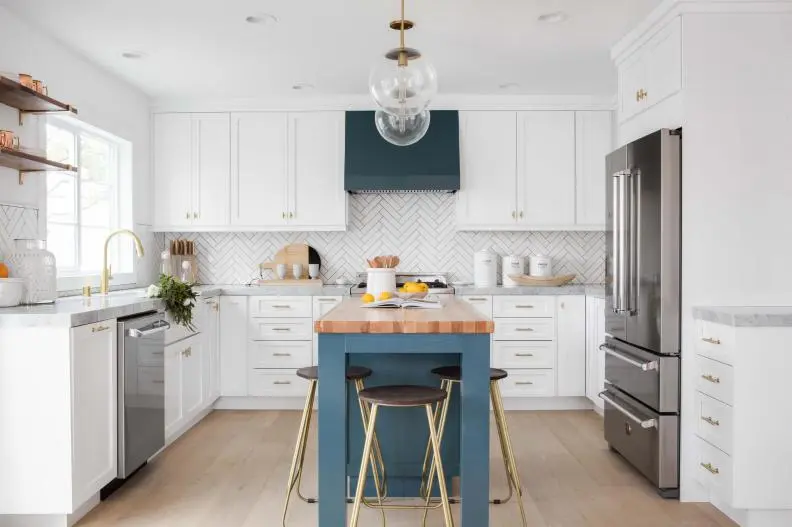 Blue Gray Island with three seating stools in a white kitchen