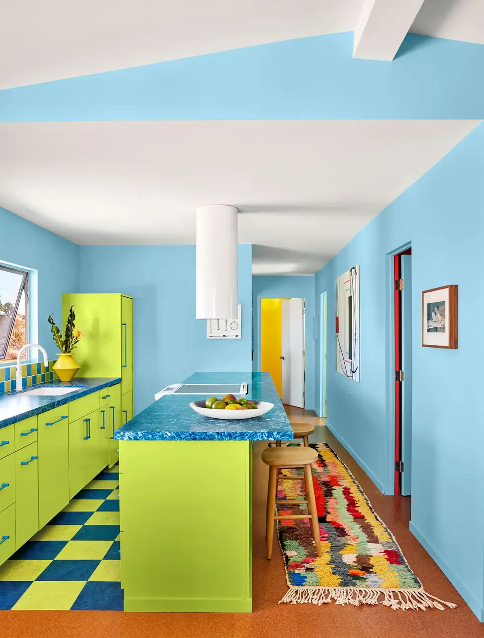 A modern kitchen with Vibrant acid green cabinets and island and blue accents