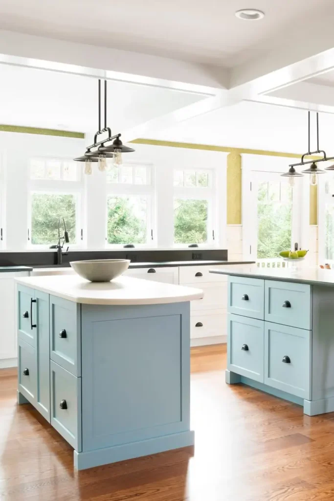 a beautiful kitchen with two matching islands are placed back-to-back