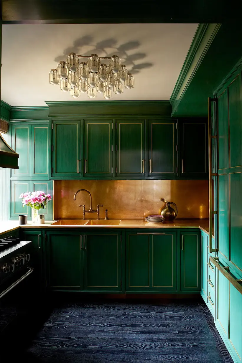 Emerald Green Kitchen Cabinets with brass backsplash and trim