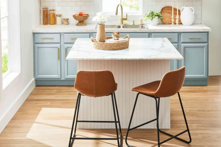 A small kitchen Island with 2 chairs