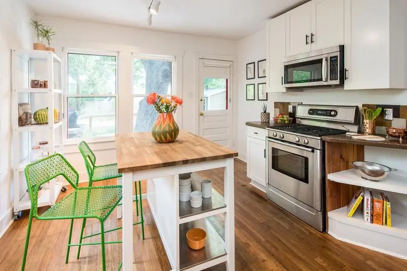 Hyper Functional kitchen Island with bright green stools and butcher-block top with open shelves .