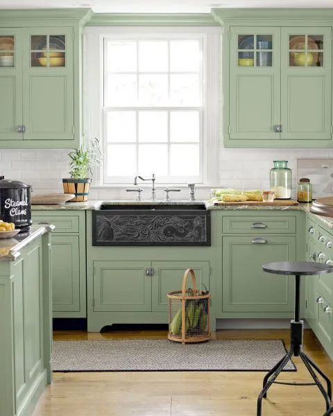 A beautiful kitchen with Light Green Cabinets and light green counter and island cabinets with the white surrounding walls