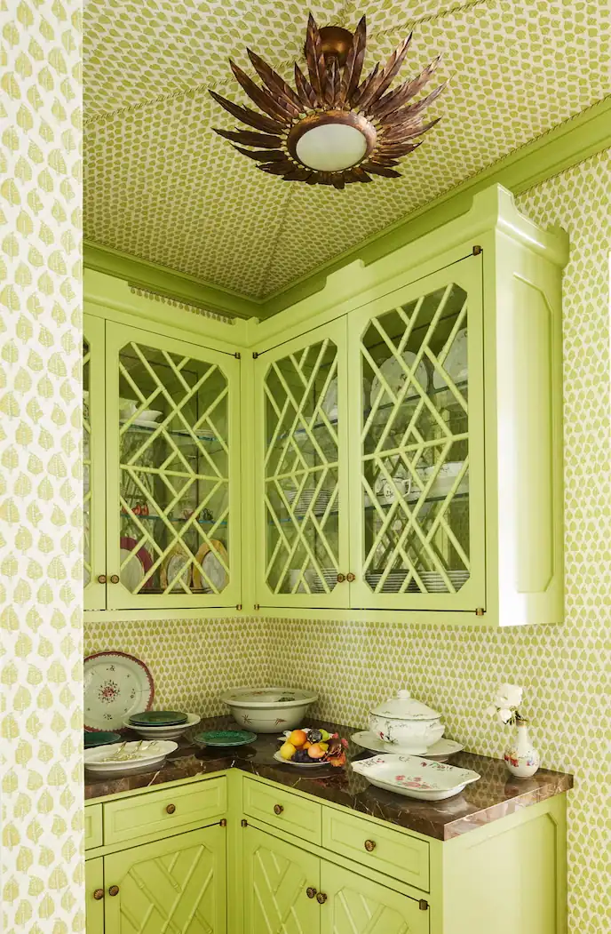 A beautiful kitchen with Lime Green Cabinets with Benjamin Moore's Shades of Spring coats on the upper and lower cabinets, with a wallpaper by Peter Fasano 