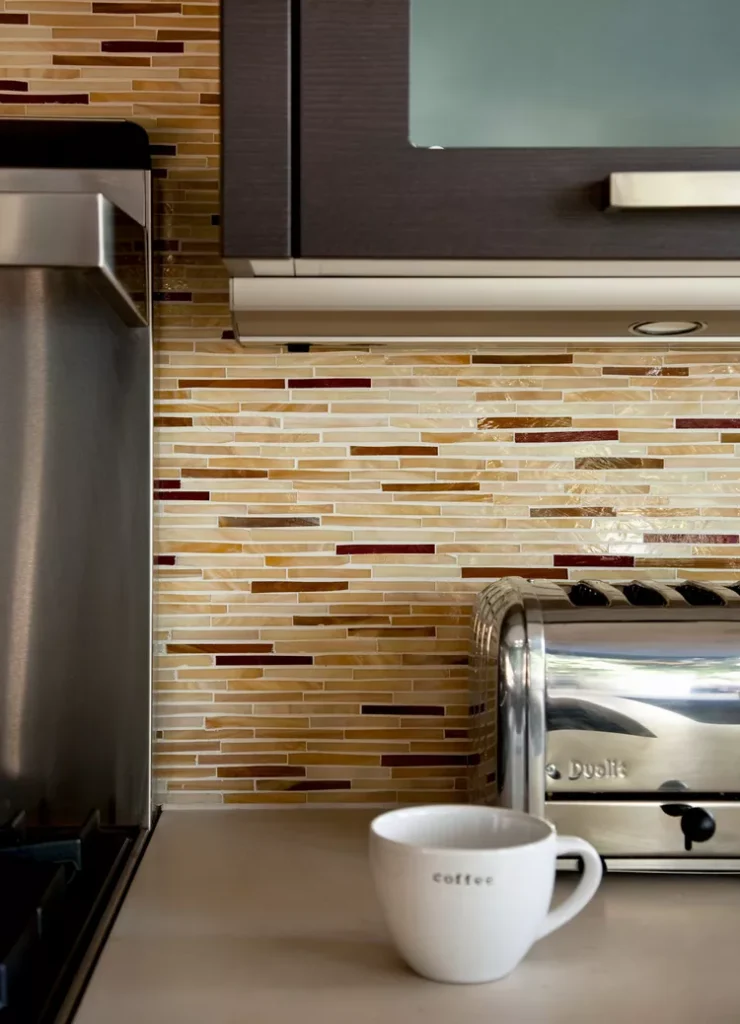 Modern Mosaic Backsplash with slim glass tiles in soft creams and stone tiles in rich copper tones