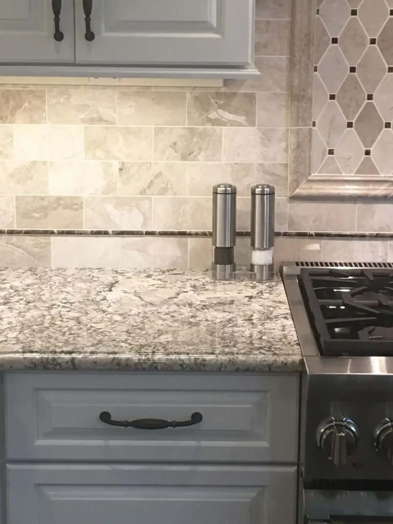 Marble backsplash with granite kitchen countertop