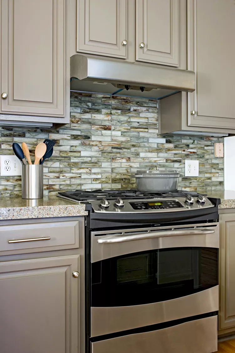 Recycled glass tiles backsplash with the warm gray, cream, and brown color palette