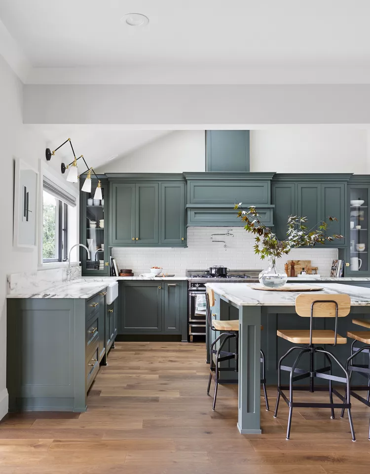 Teal Green Kitchen Cabinets with trace of blue and the wooden benches on the island.