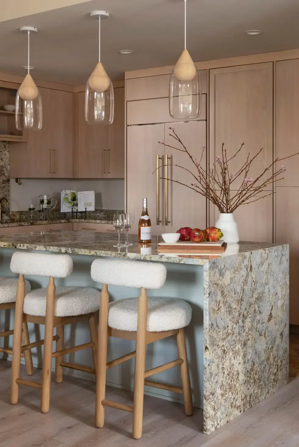 Waterfall Island with granite top and chairs in a modern kitchen