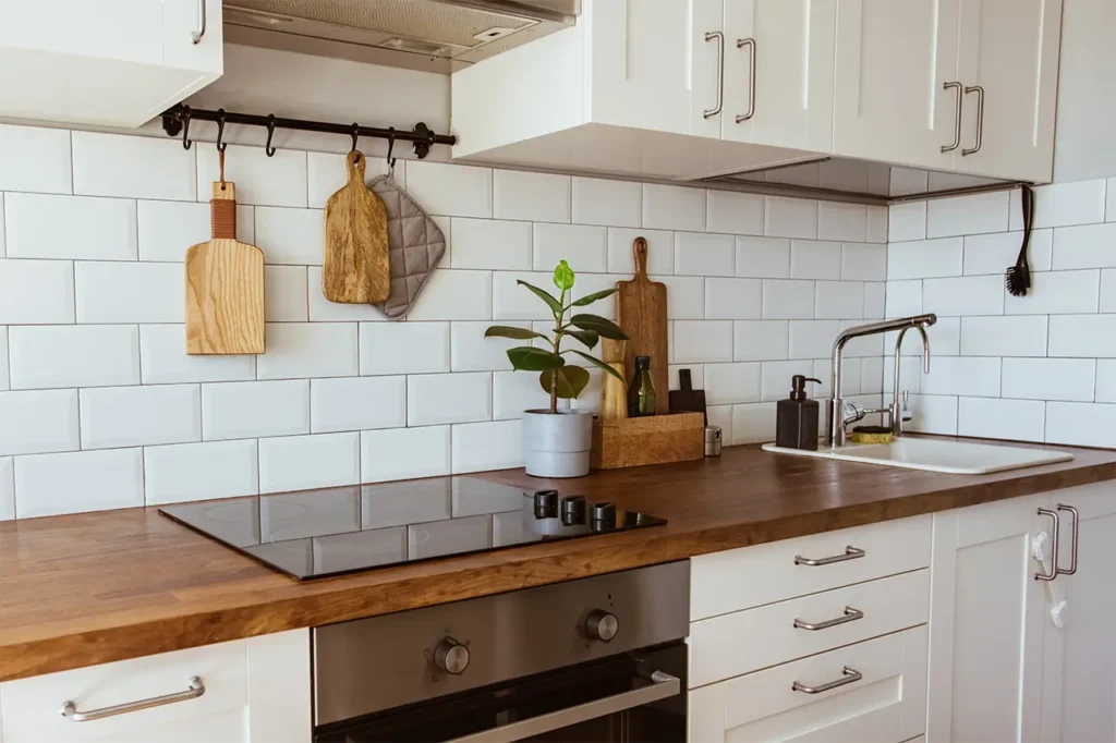 A kitchen with Wooden Countertop and tile backsplash 