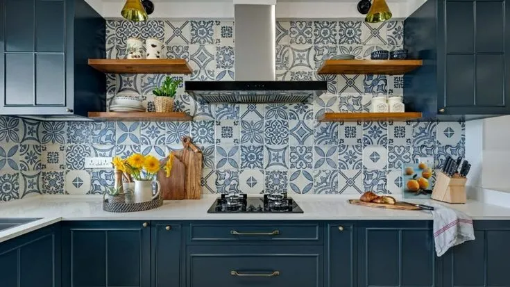 A busy backsplash with granite countertop