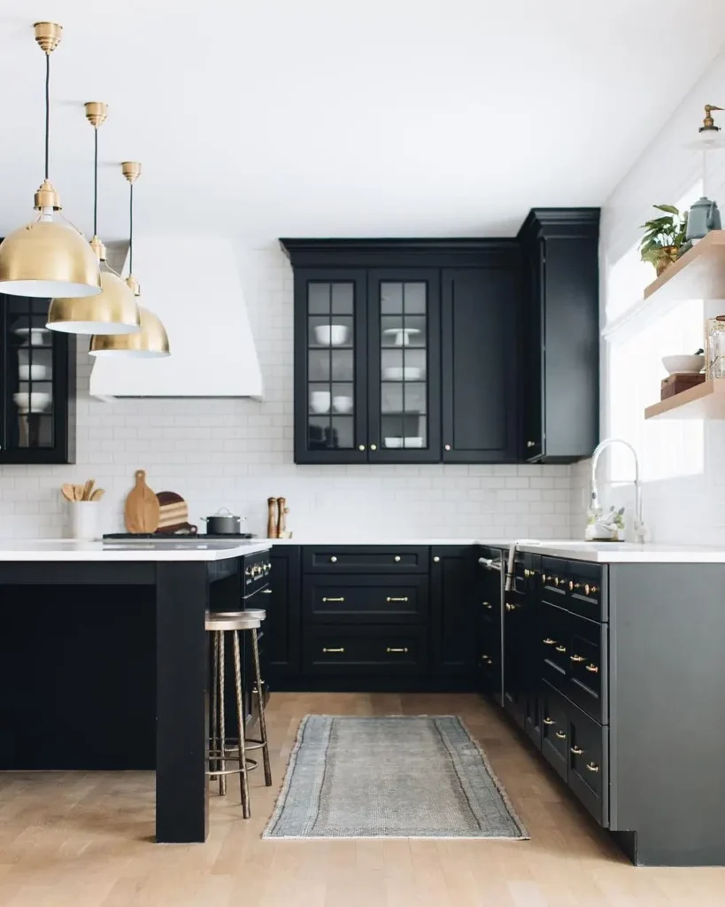 modern kitchen with black cabinets and white countertop