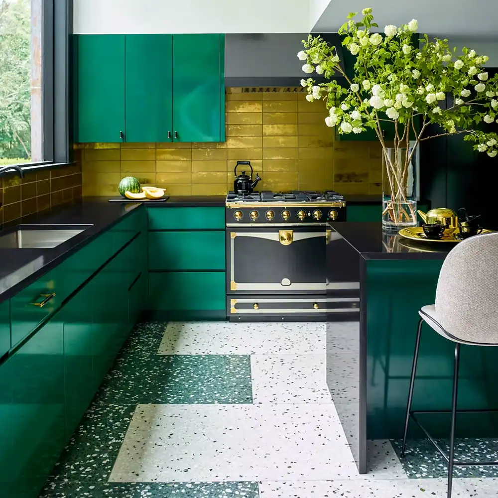 A modern kitchen with green cabinets and yellow backsplash