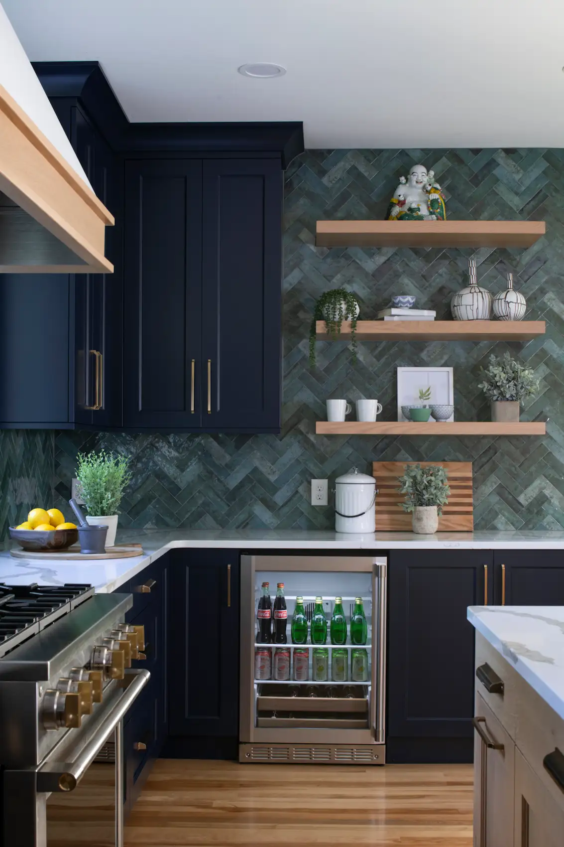 Deep Black Kitchen Cabinets, green chevron tiles, and floating wood shelves in a modern kitchen 