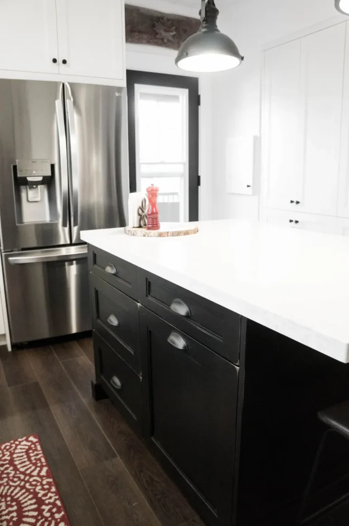 Kitchen with Dark flooring and black cabinets 